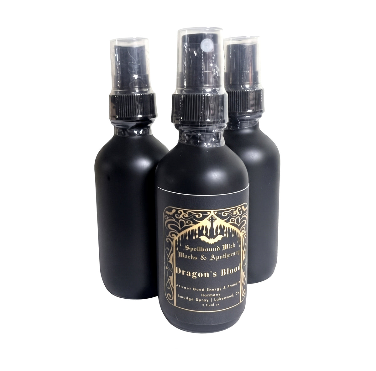 Three matte black spray bottles with clear spray tops standing together on a white background.