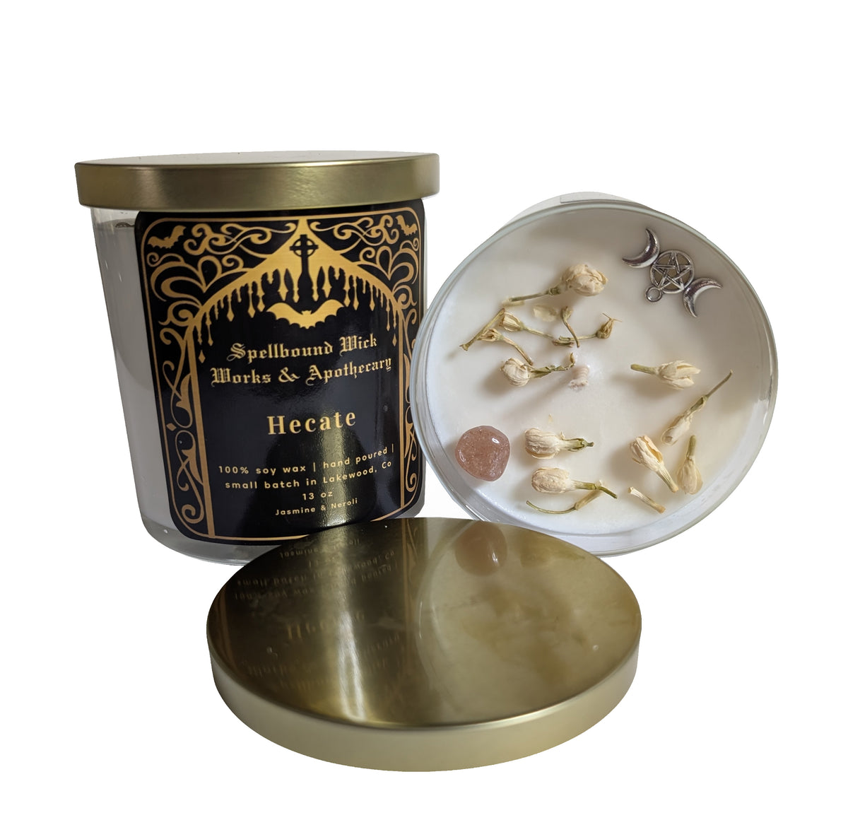 The Hecate Goddess Candle seen from above with the lid removed, next to a white dish of bone charms