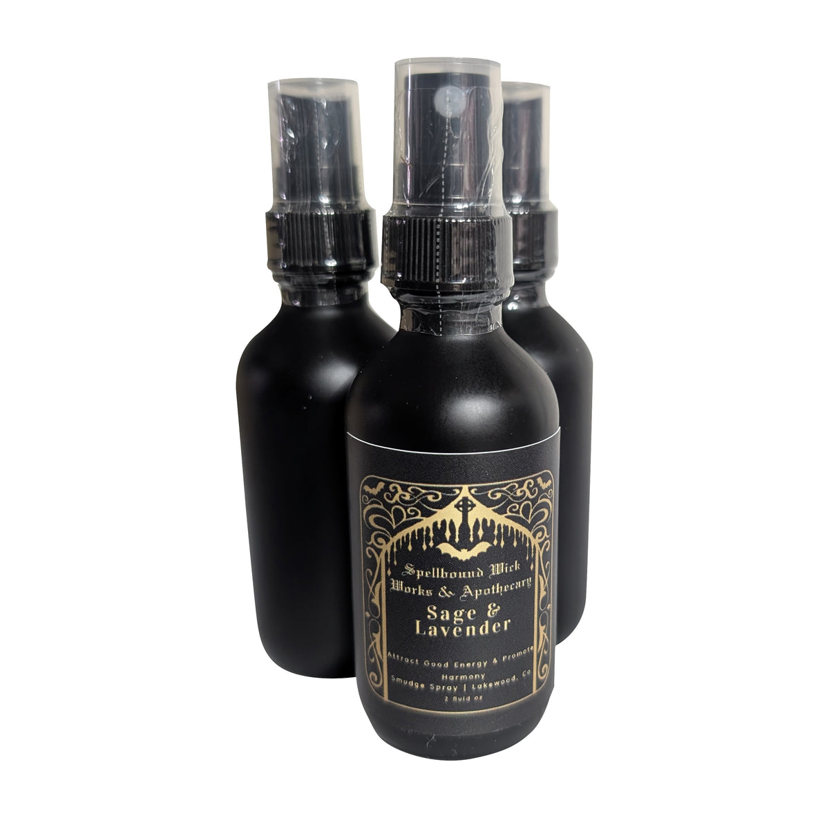 Matte black spray bottles with clear spray tops standing together on a white background.