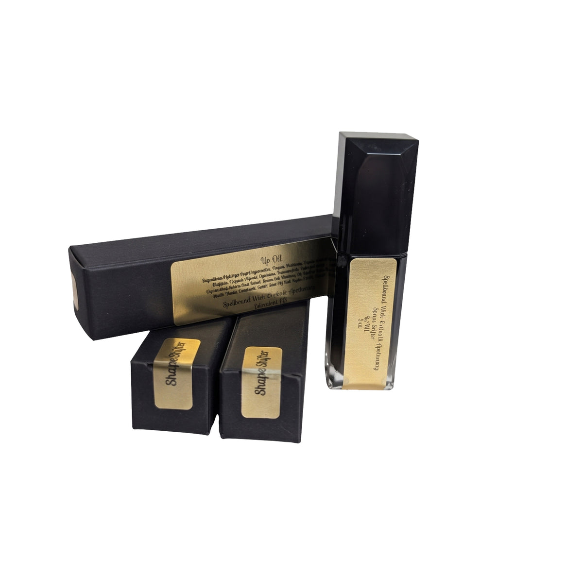 Black lip oil bottle and its black gold labeled boxes arranged on a white background.