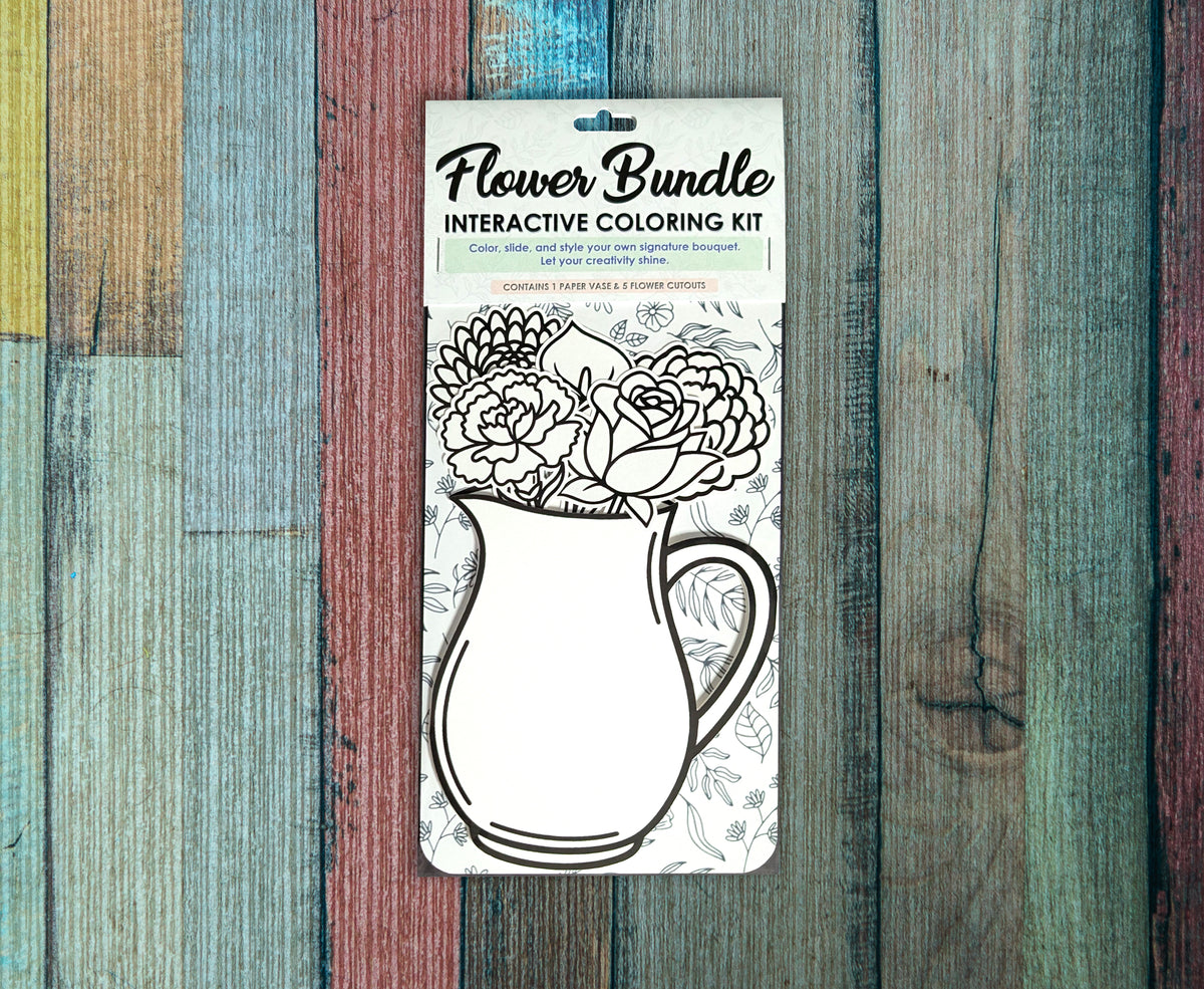 Single Flower Bundle interactive coloring kit lying on a painted wood background, the uncolored roses and pitcher cutouts showing through the front of the package below the Flower Bundle header card.
