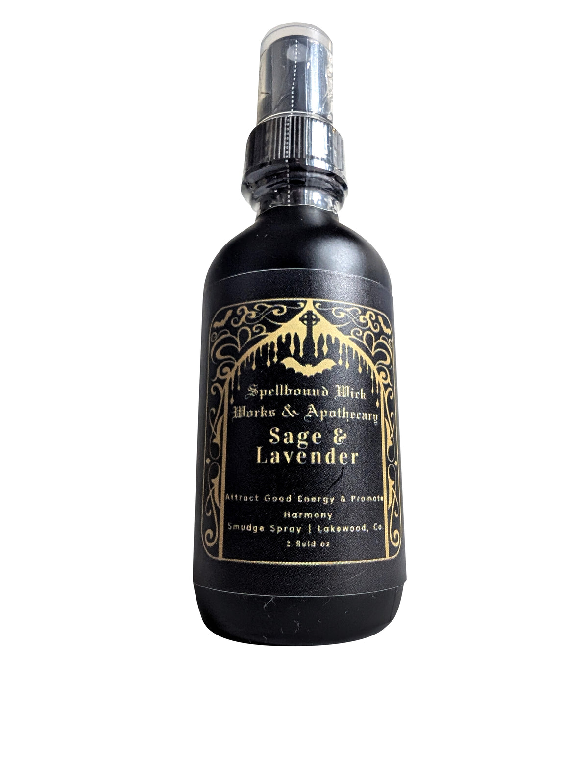 Front view of the matte black spray bottle with its clear plastic spray top and gold foil label on a white background.