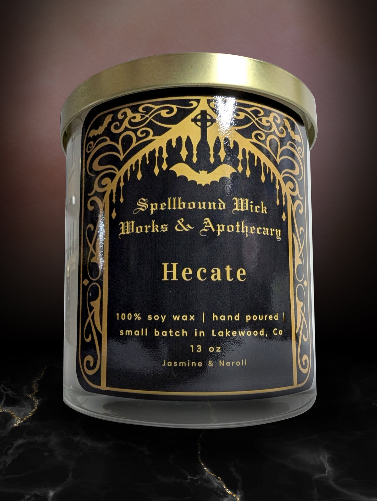 The Hecate Goddess Candle closed with its gold lid on, against a dark background