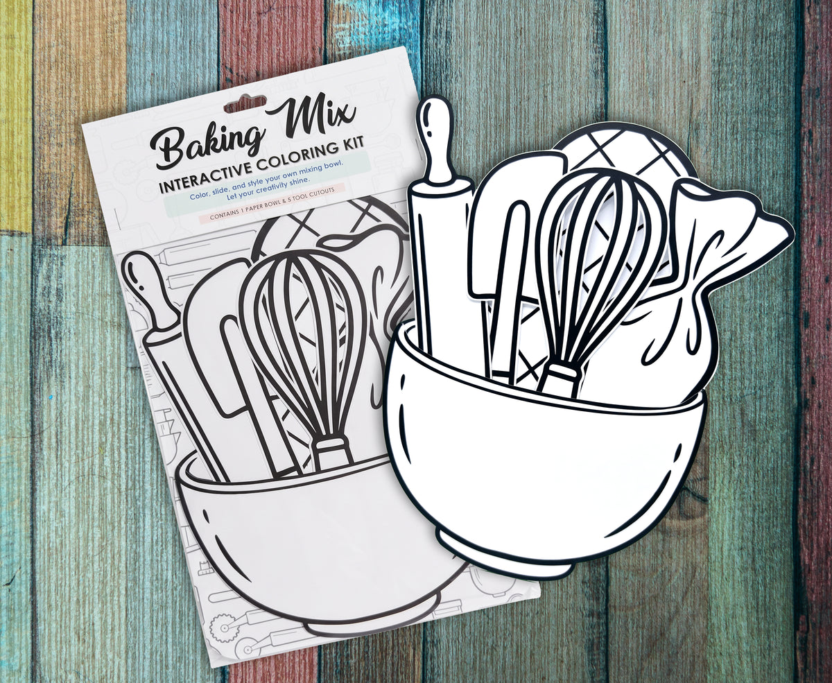 Two Baking Mix interactive coloring kits in their packaging on a painted wood background, showing the uncolored mixing bowl, whisk and rolling pin cutouts behind the Baking Mix header card.