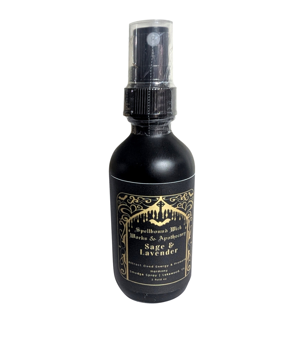 Matte black spray bottle photographed at an angle on a white background with the gold label centered.