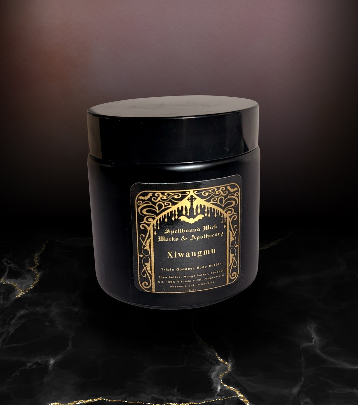 Closed black jar of body butter on marble, the gold arched label reading Xiwangmu facing forward.