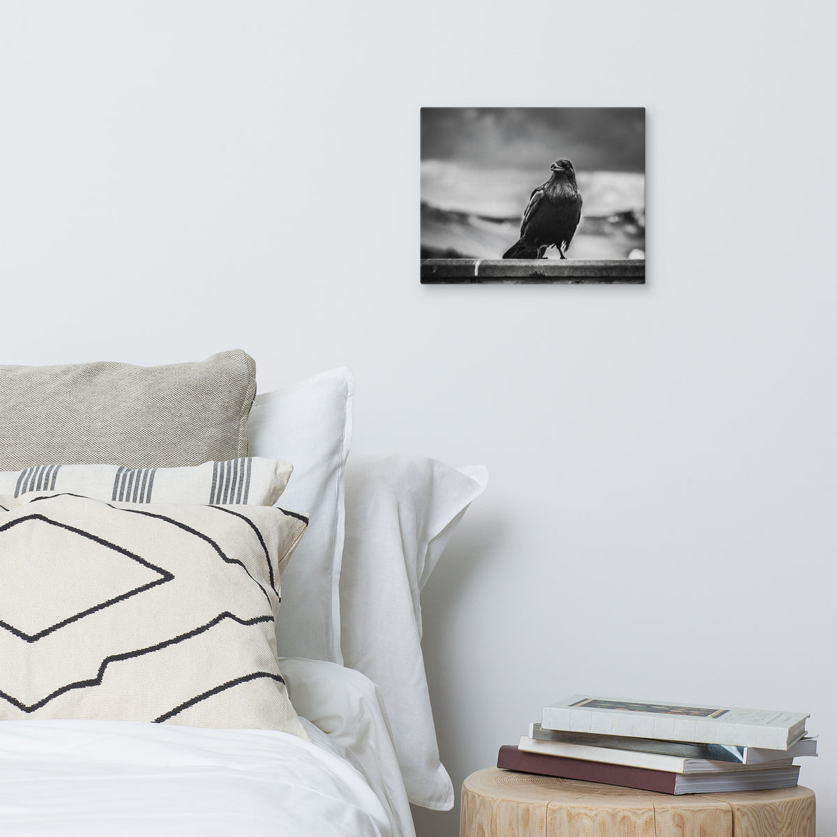 Crow So Chic canvas print by Iain Camacho, medium canvas hanging above a bed with white and patterned pillows