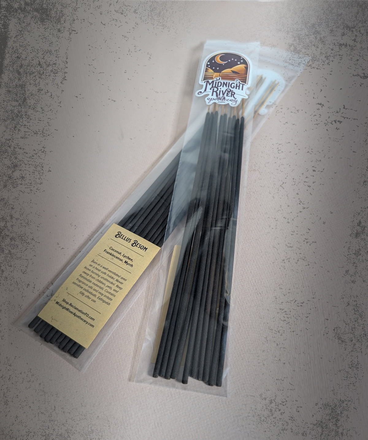Bag of Bellus Besom hand dipped incense by Midnight River Apothecary on a gray textured surface, with the yellow label showing the scent contents.