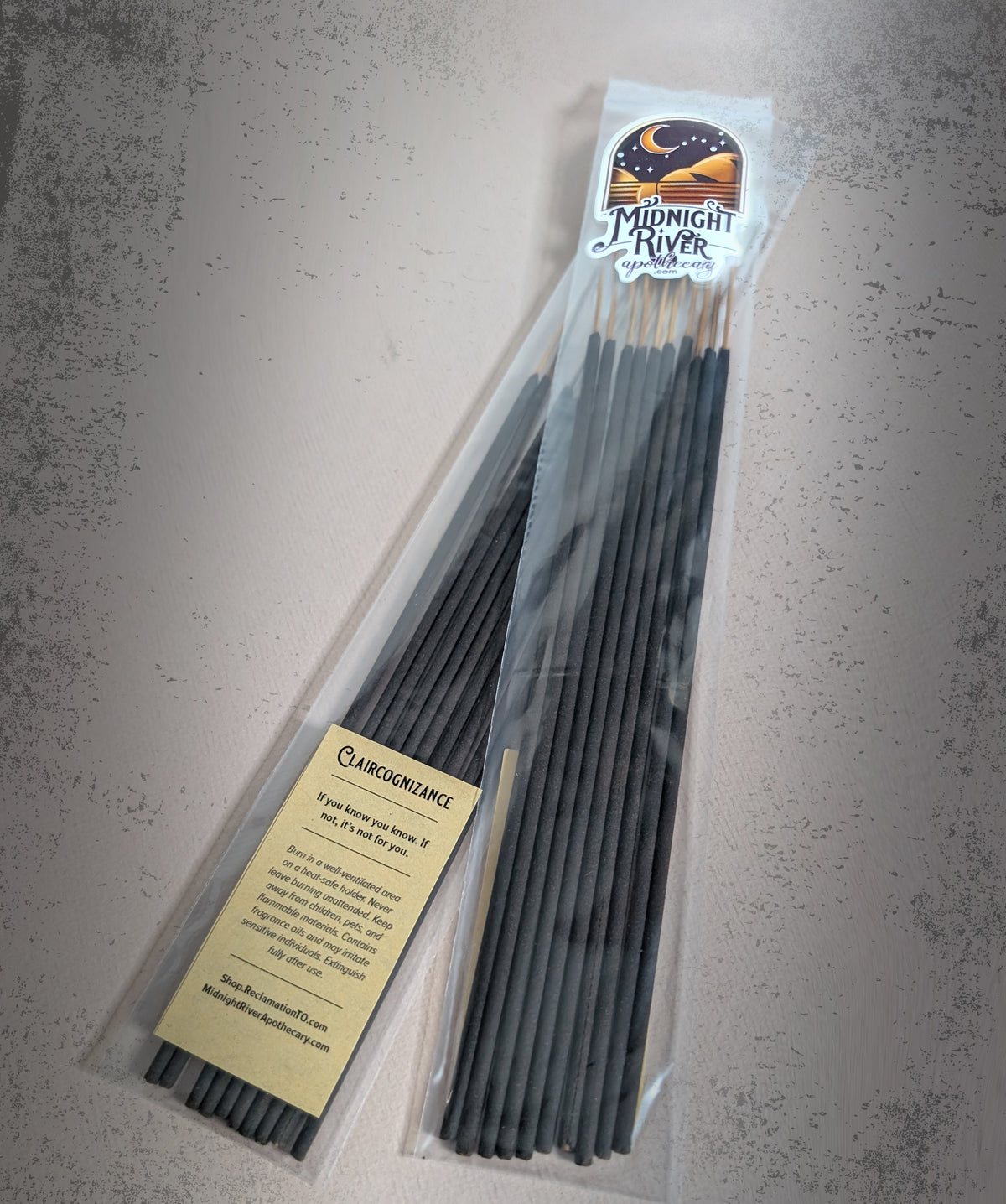 Bag of Claircognizance hand dipped incense by Midnight River Apothecary on a gray textured surface, with the yellow label showing the scent text.