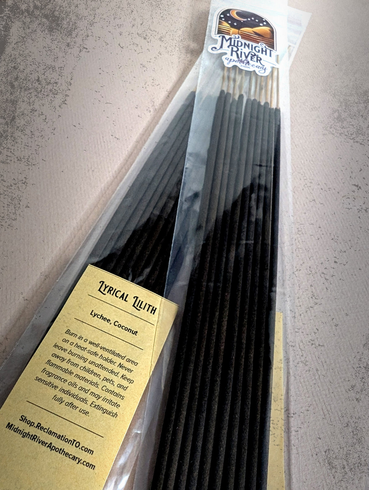 Second angle of the Lyrical Lilith incense bag from Midnight River Apothecary, with the yellow label and the black sticks inside.