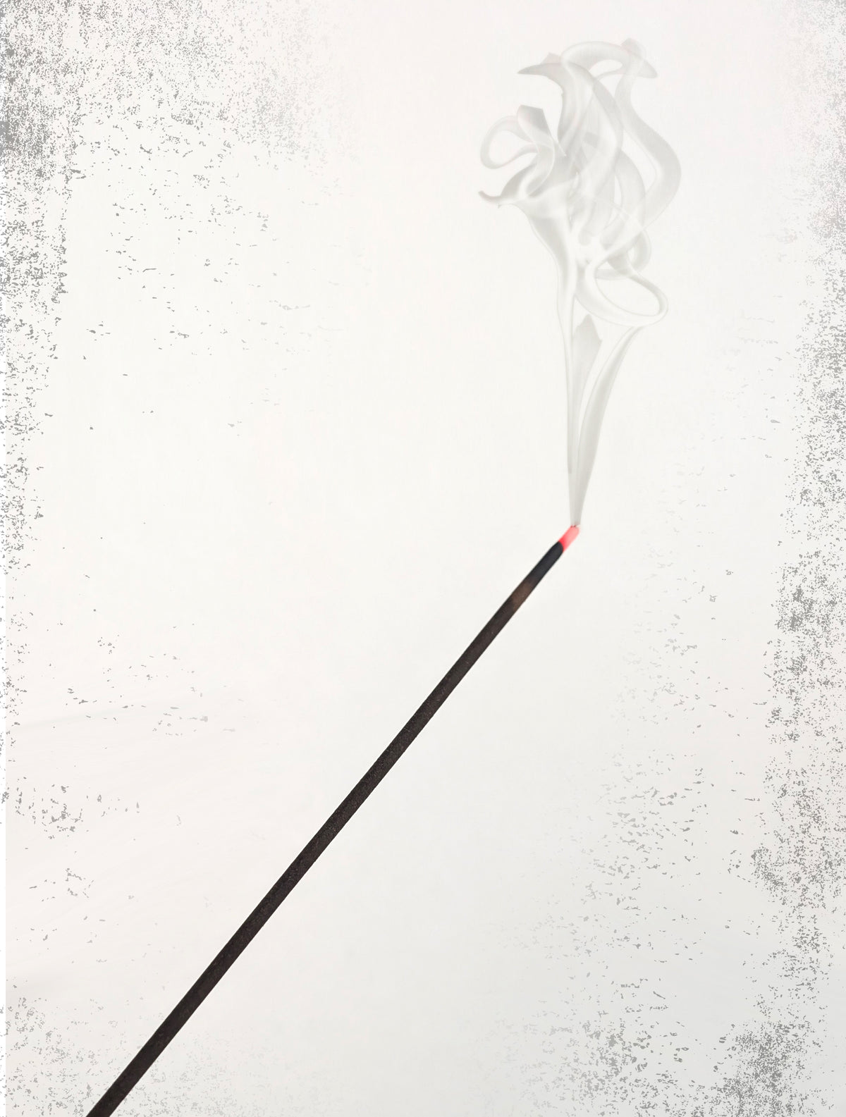 Single black incense stick burning with a thin trail of smoke against a plain white background.