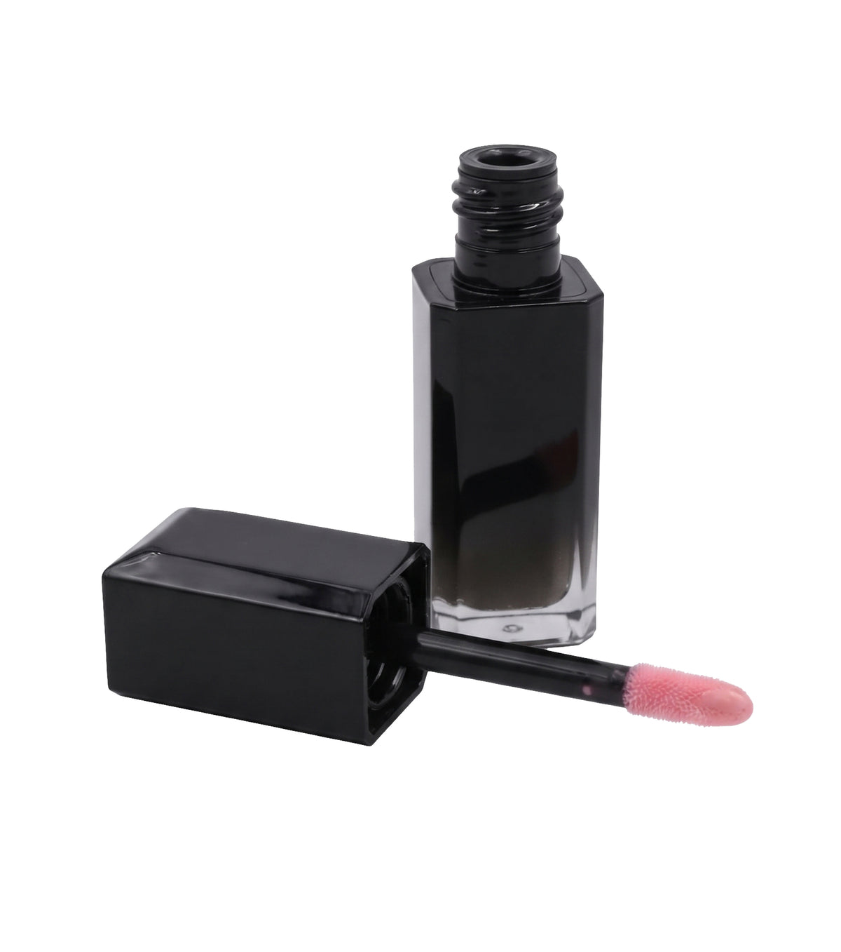 Open black lip oil bottle with the cap beside it on a white background, pale pink oil on the doe foot applicator.