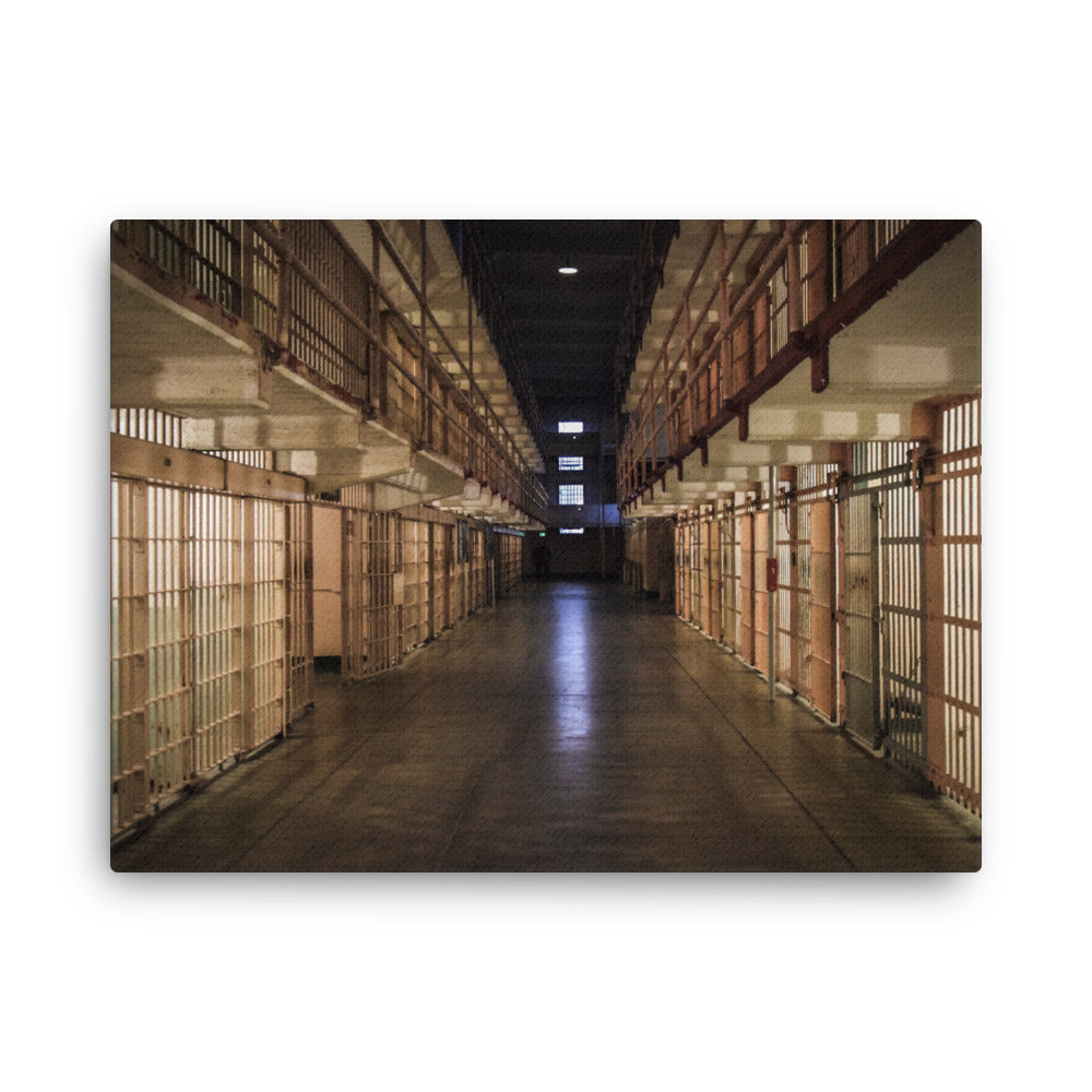 Alcatraz, San Francisco thin canvas print by Iain Camacho, front view of a photograph of a long prison corridor lined with rows of cells under warm lights, with a dark center aisle