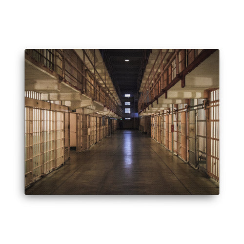 Alcatraz, San Francisco thin canvas print by Iain Camacho, front view of a photograph of a long prison corridor lined with rows of cells under warm lights, with a dark center aisle