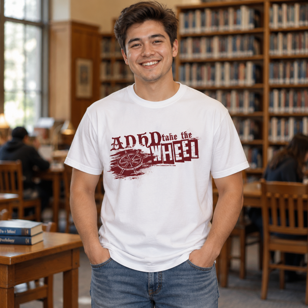 Model wearing the ADHD Take the Wheel t-shirt in white in a library, the ship's helm and distressed dark red lettering printed across the chest