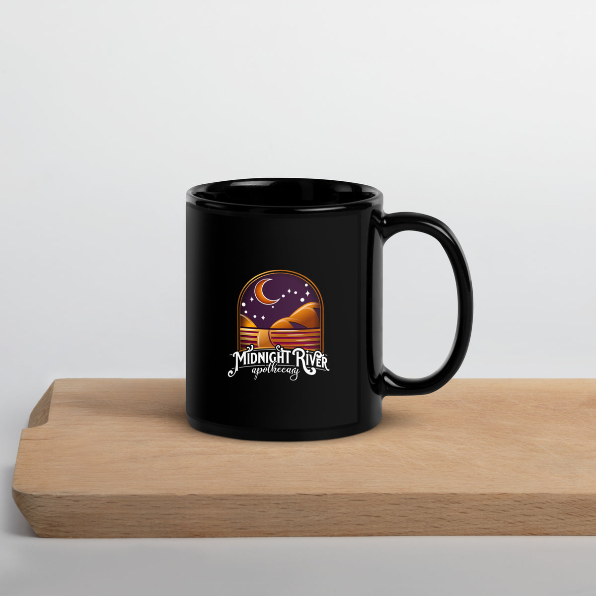 Reclamation & Midnight River mug, angled with the handle on the right, the Midnight River Apothecary badge facing the camera
