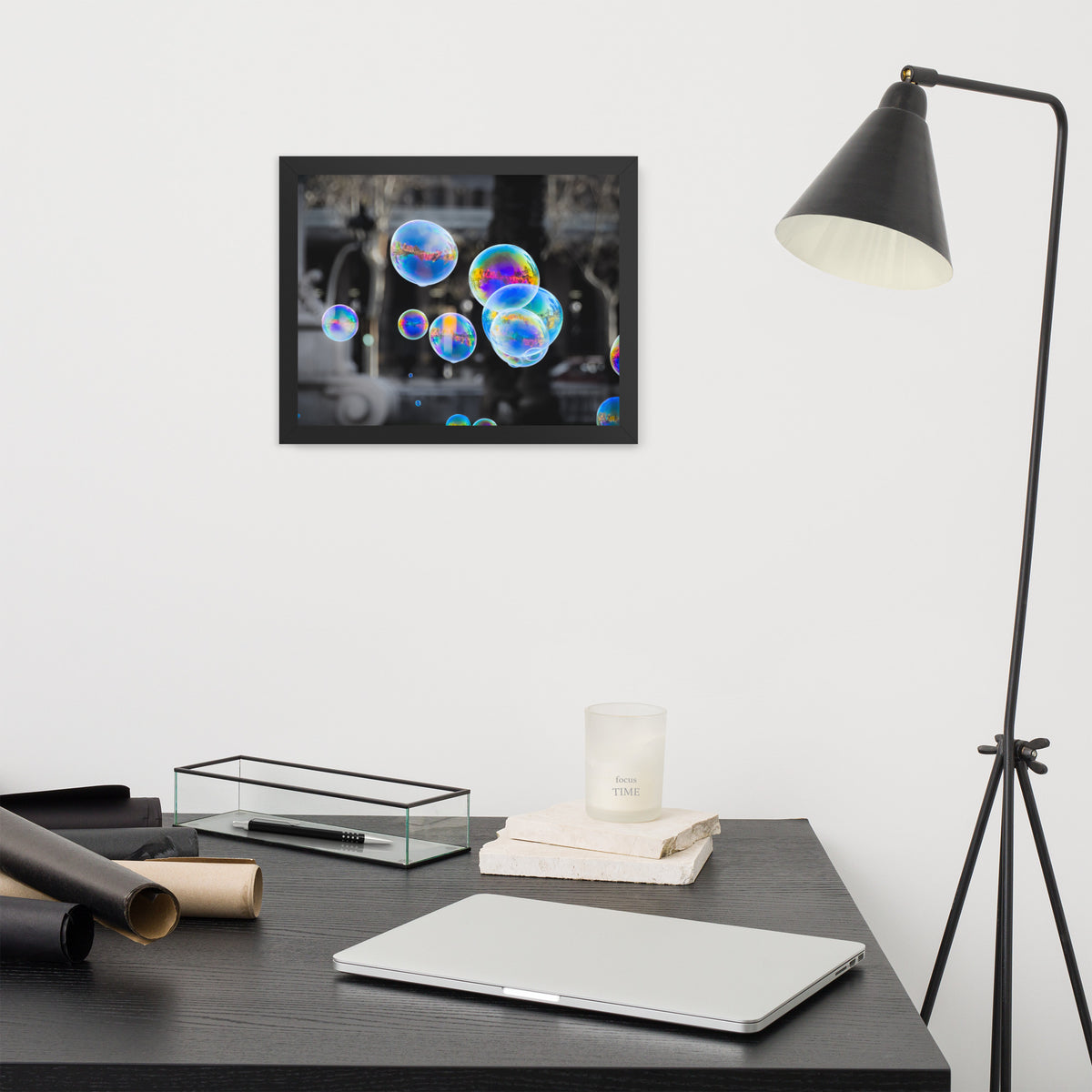 Bubbles of Barcelona framed luster print by iain, smaller black framed print hanging above a desk next to a black floor lamp