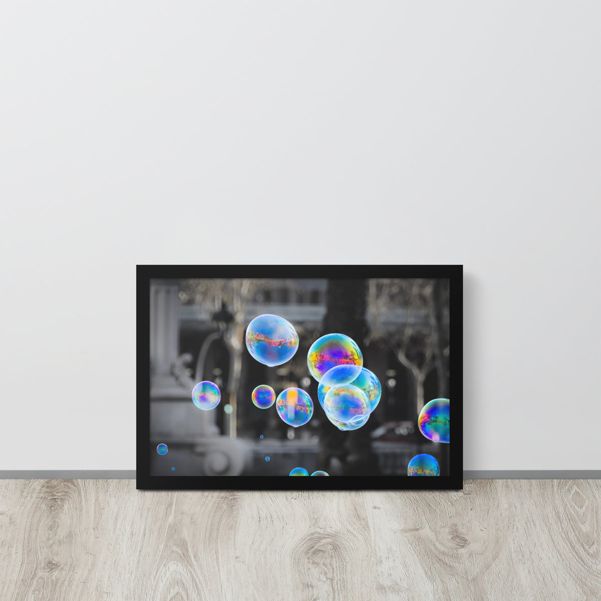 Bubbles of Barcelona framed luster print by iain, black framed print resting on a light wood floor against a white wall