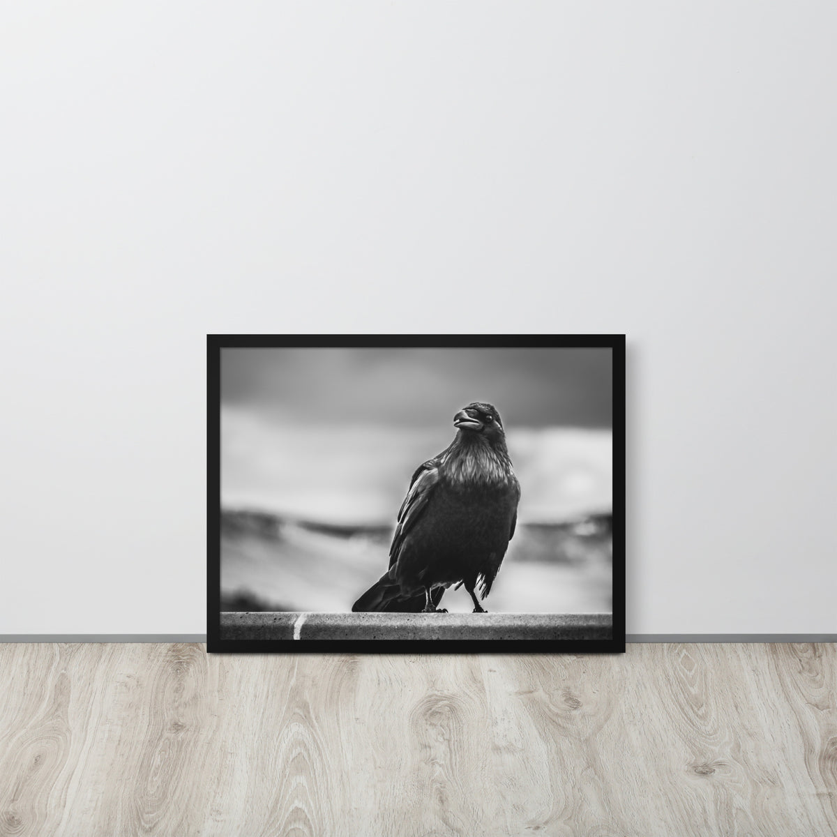 Crow So Chic framed luster print by iain, larger black framed print resting on a light wood floor against a white wall