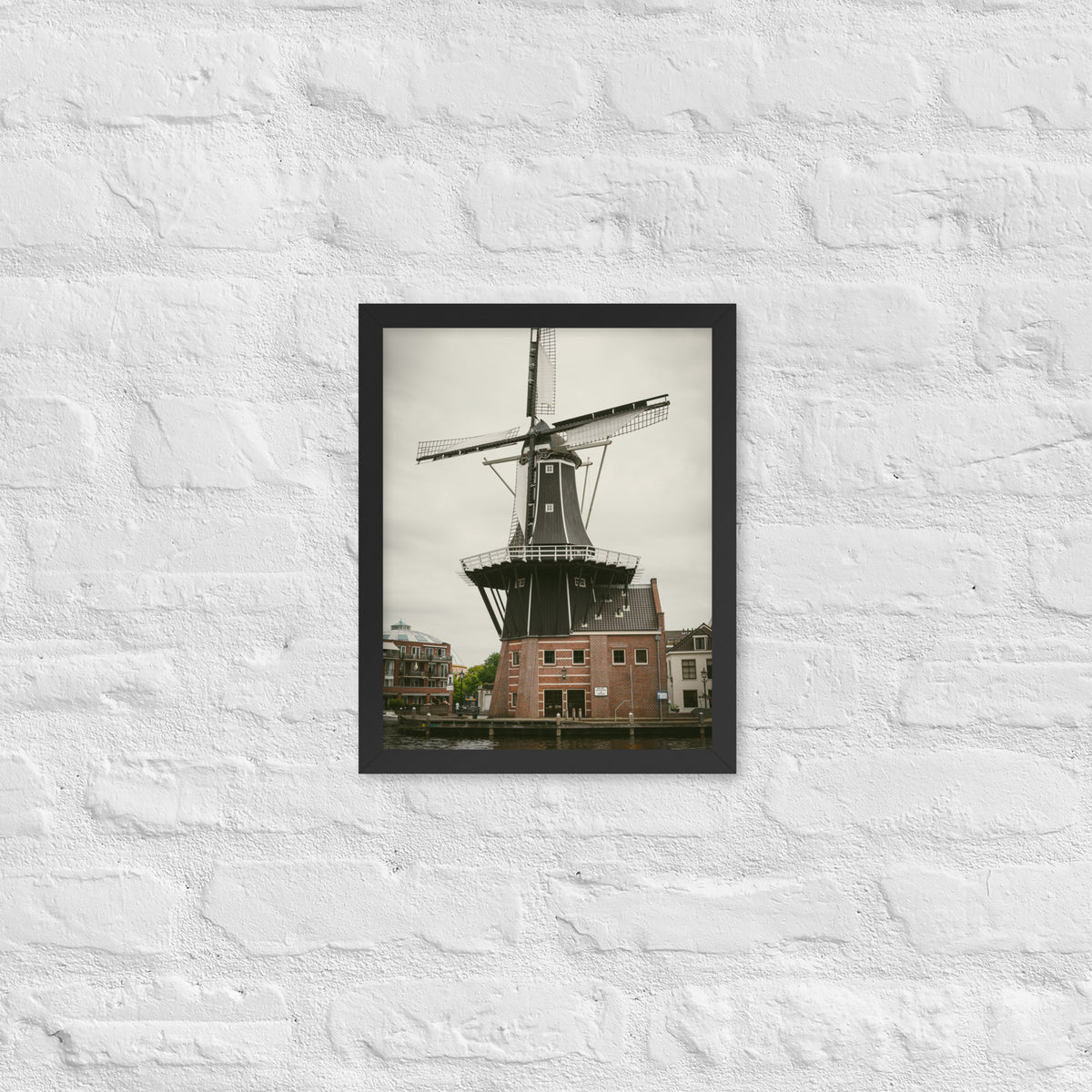 De Adriaan, Haarlem framed luster print by iain, smaller black framed print hanging on a white brick wall