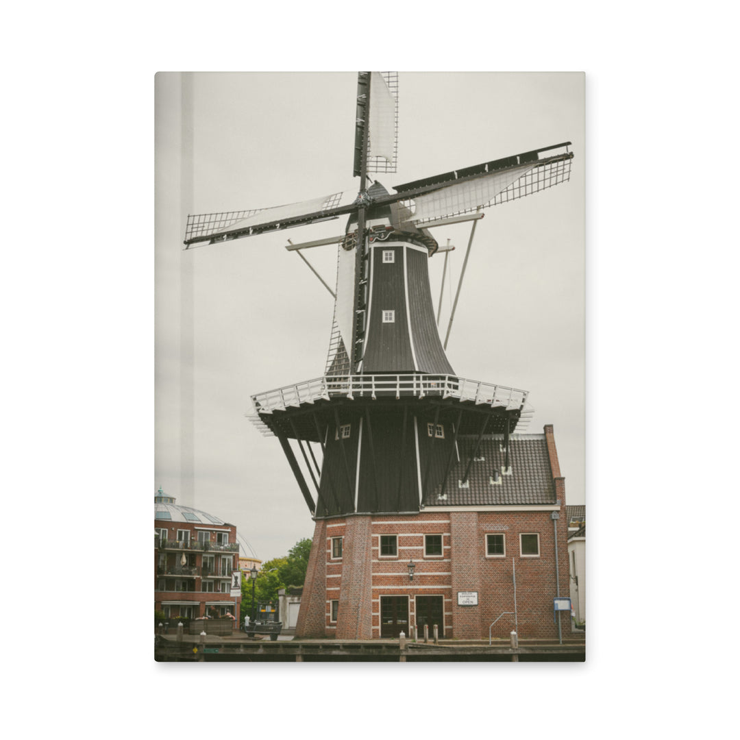 De Adriaan Windmill hardcover journal by iain, journal standing upright on a white background, with a photograph of the De Adriaan windmill in Haarlem and its brick building on the front cover and the page edges showing on the side
