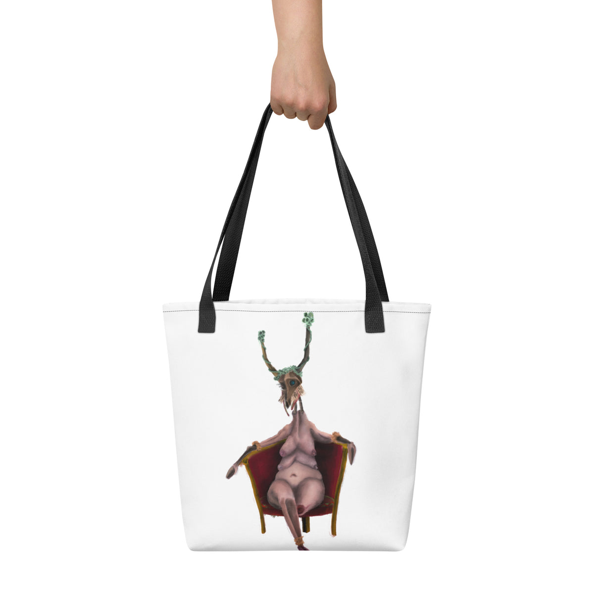White tote bag held up by a hand against a neutral background, displaying the scale and vertical placement of the front graphic.