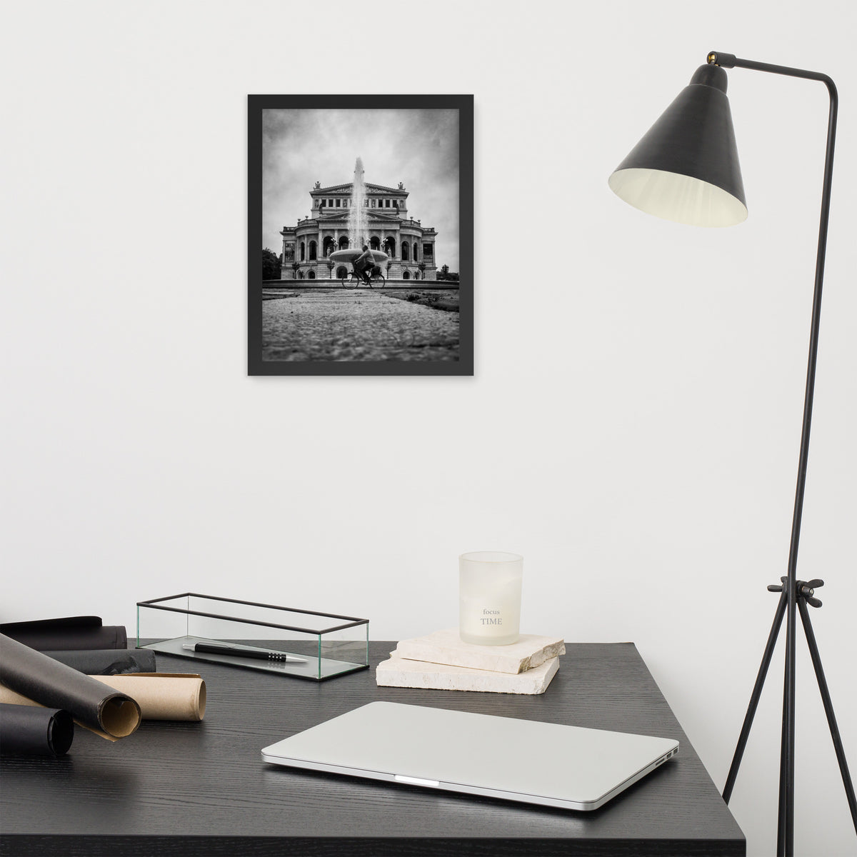 German Precision framed luster print by iain, smaller black framed print hanging above a desk next to a black floor lamp