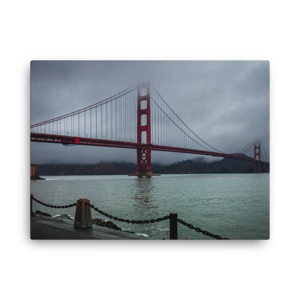 Golden Gate Bridge, San Francisco thin canvas print by Iain Camacho, front view of a photograph of the red bridge fading into low fog over gray water, with a chain railing in the foreground