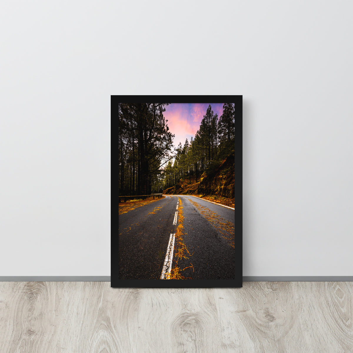 Mountain Road framed luster print by iain, black framed print resting on a light wood floor against a white wall