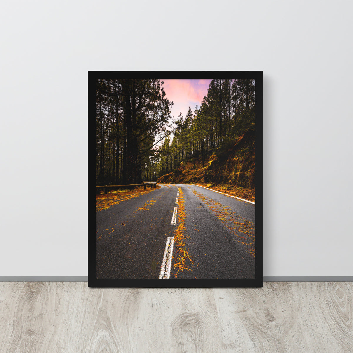 Mountain Road framed luster print by iain, larger black framed print resting on a light wood floor against a white wall