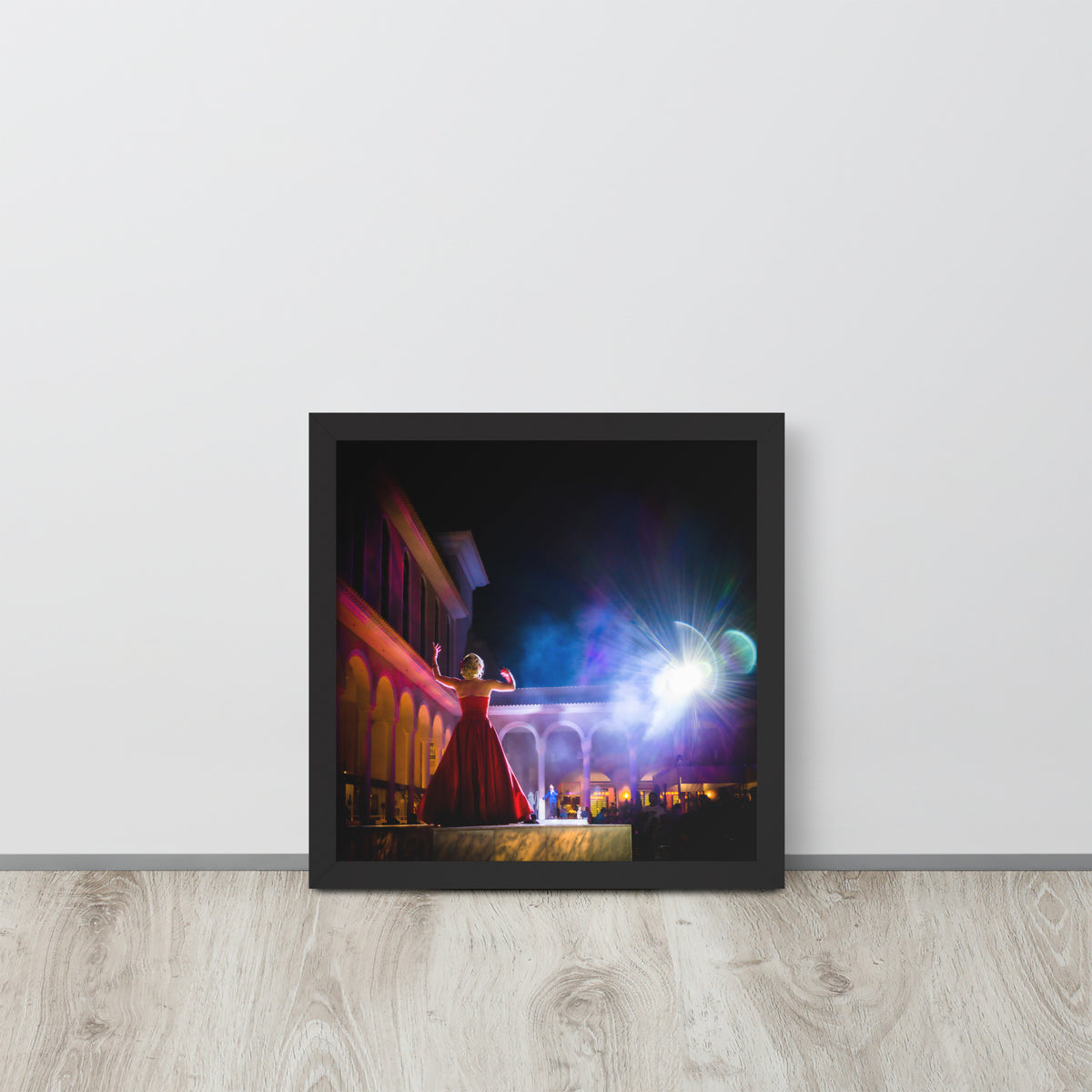 Perform for the Gods framed luster print by iain, square black framed print resting on a light wood floor against a white wall