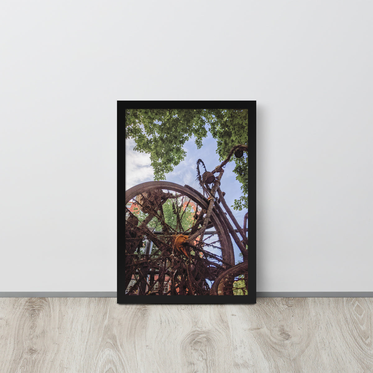 Rusty Bicycle framed luster print by iain, black framed print resting on a light wood floor against a white wall
