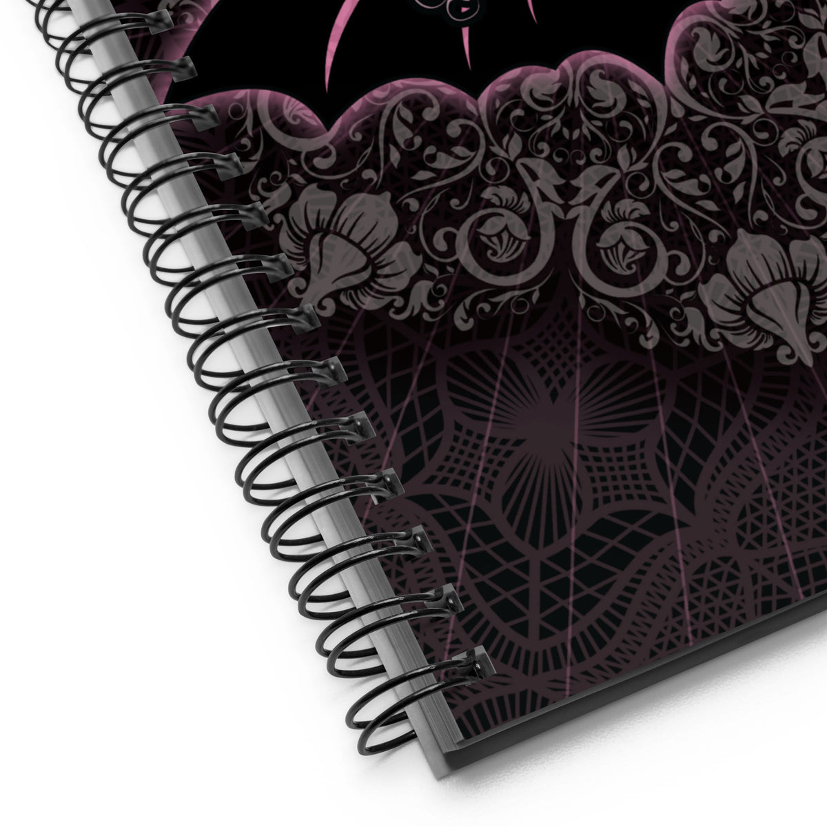 Close up of the cover art and black wire binding, showing the fine lace and floral line work in detail