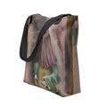 White polyester tote bag featuring an all-over print of a robed, hooded figure with a patterned brown hood and garment standing against a textured backdrop.