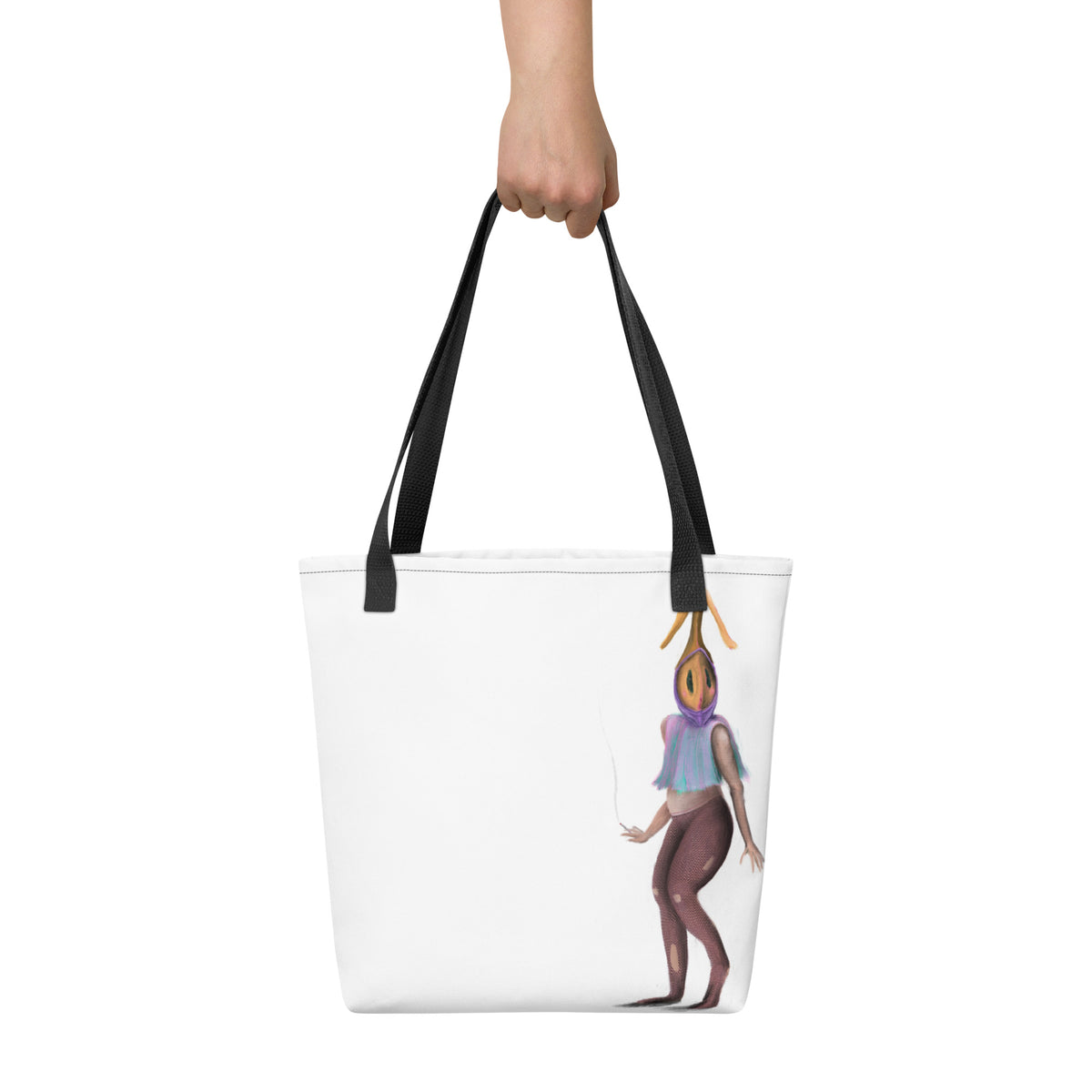 White tote bag held up by a hand against a neutral background, displaying the scale and vertical placement of the front graphic.