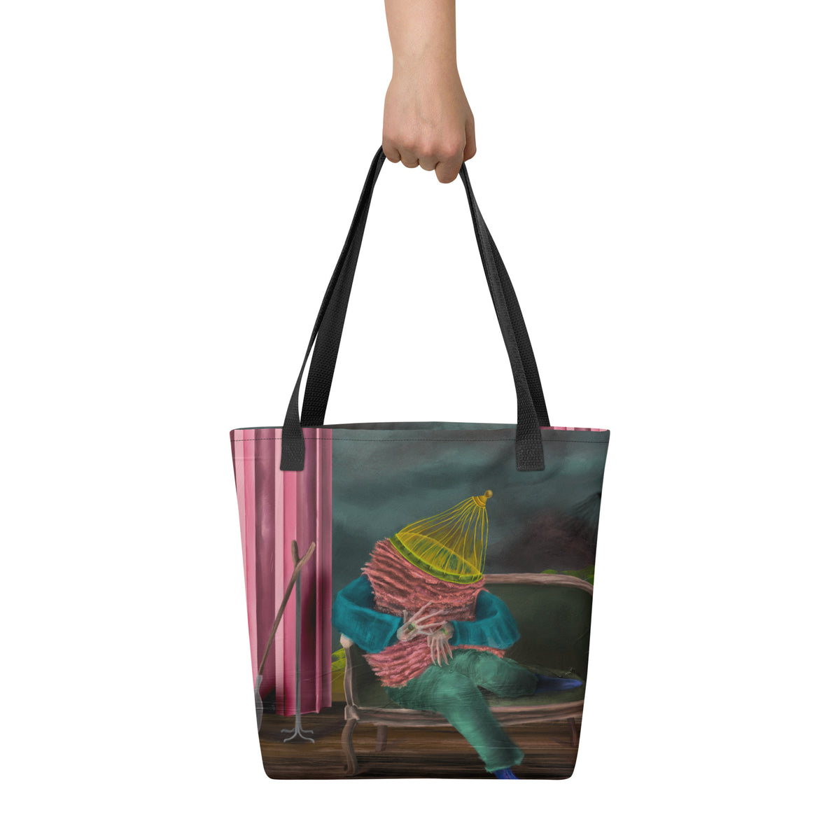 White tote bag held up by a hand against a neutral background, displaying the scale and vertical placement of the front graphic.