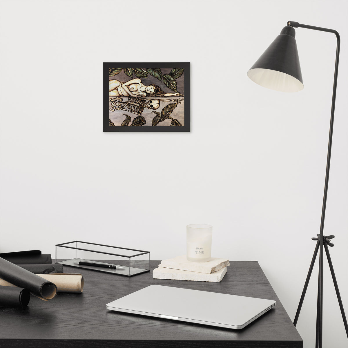 Vainglorious Contrition framed luster print by Cami Thunder, smaller black framed print hanging above a desk next to a black floor lamp