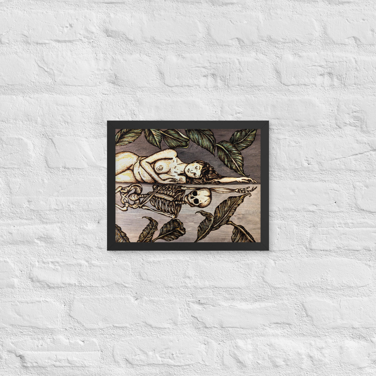 Vainglorious Contrition framed luster print by Cami Thunder, smaller black framed print hanging on a white brick wall